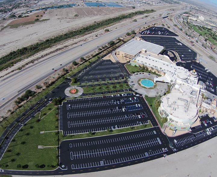 After — freshly paved and striped parking lot